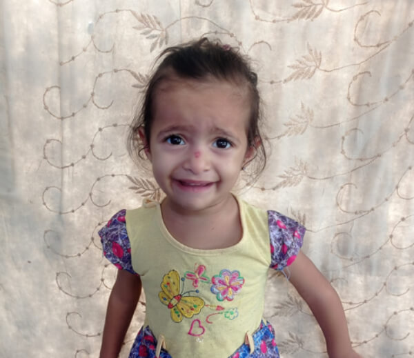 Image of girl in Gaza receiving food package from SWAN team member